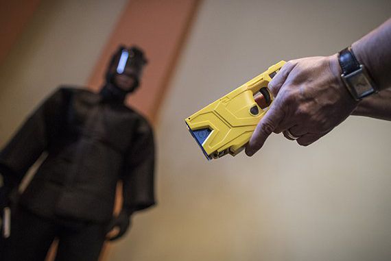 A German police officer holds a Taser gun during a press conference in Berlin, Germany